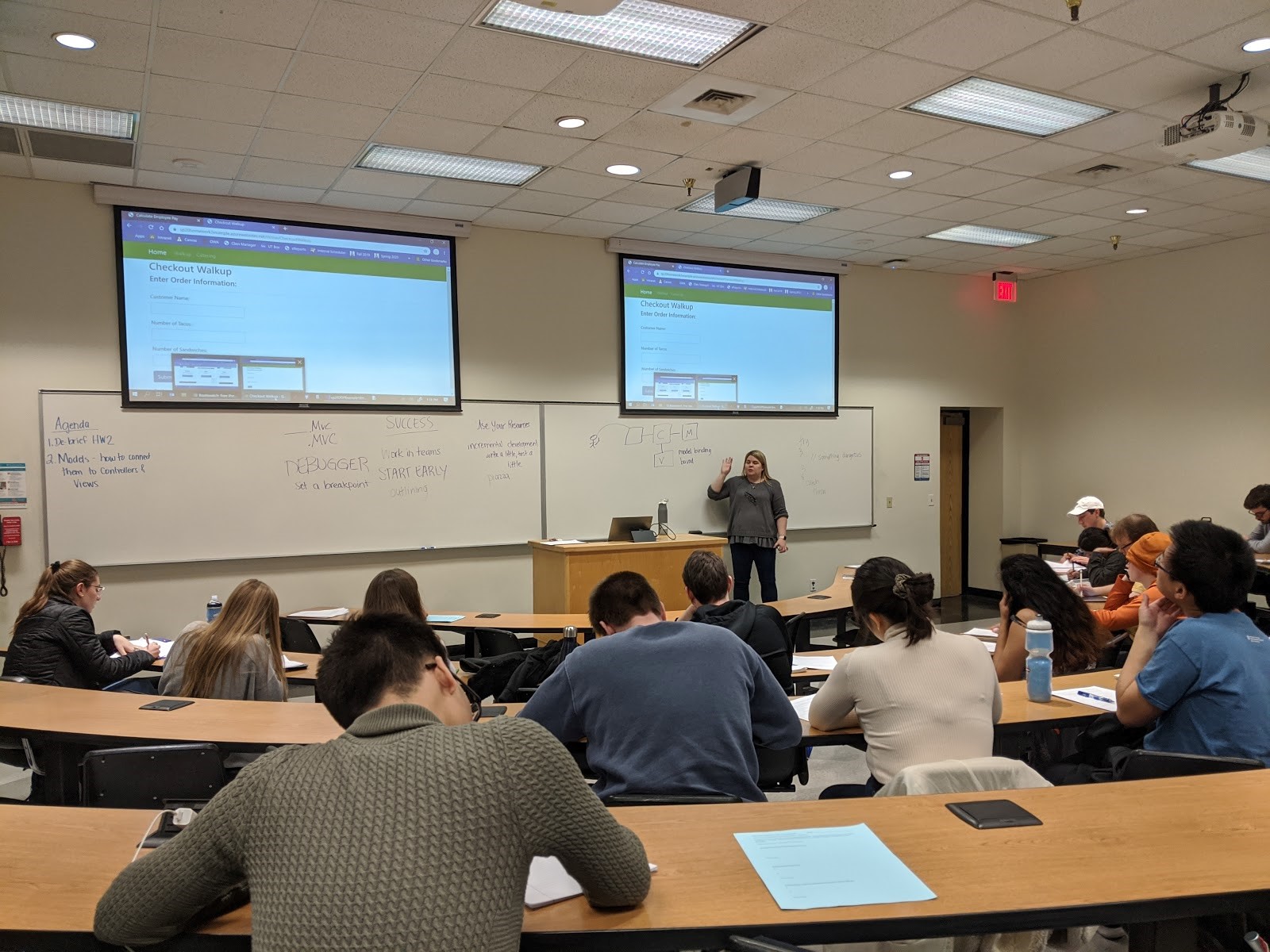 Professor Katie Gray wrangles projections and good-old-fashioned dry erase boards in her computer-less web development course