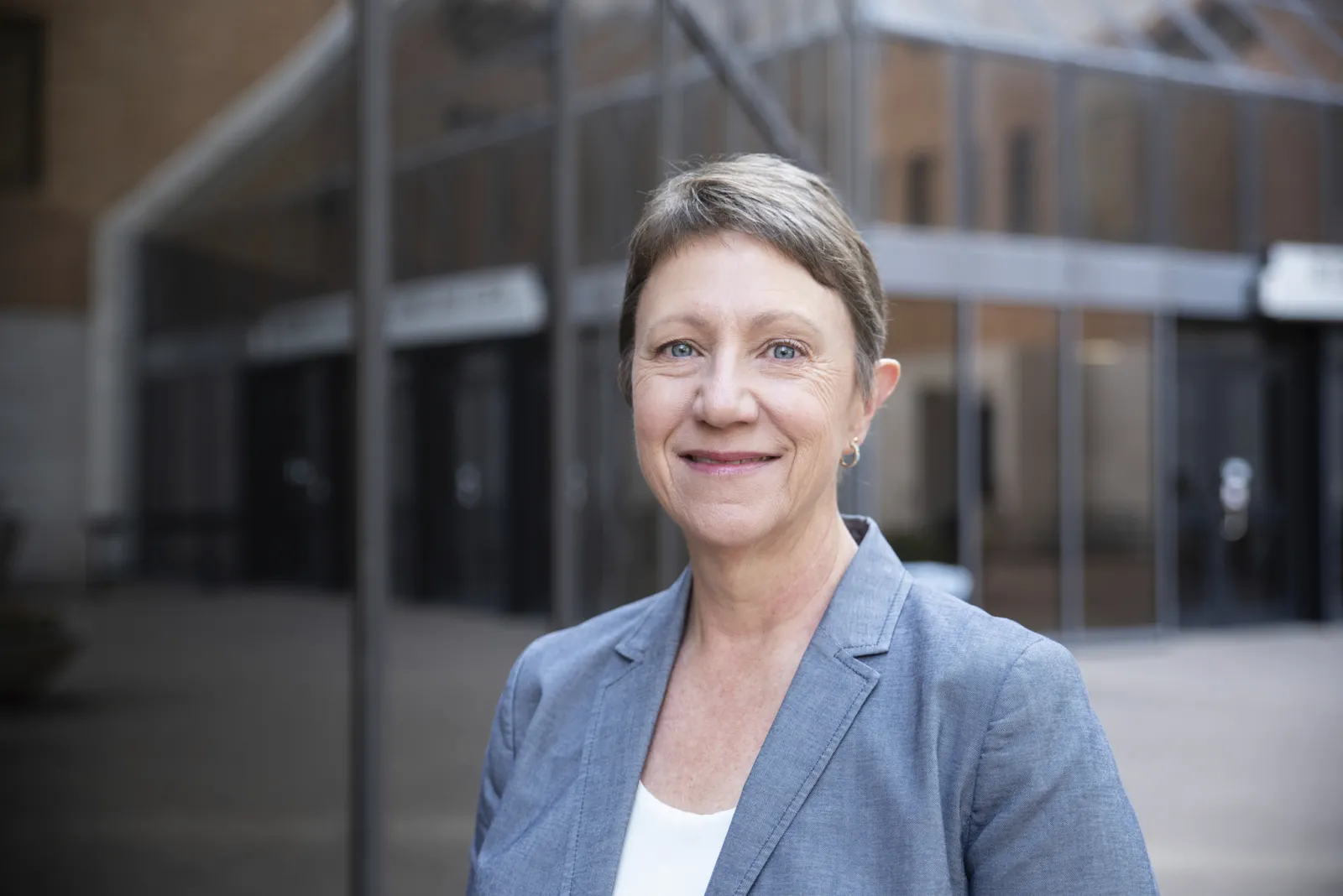 woman in suit A headshot of Heidi Toprac, a white woman, smiling in a grey blazer and white shirt.