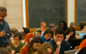 Professor in the midst of students engaged in learning activity during lecture