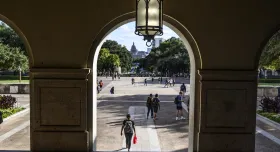 Looking at Main Mail through arch, students walking