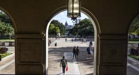 Looking at Main Mail through arch, students walking