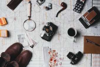 Map of Texas laid out on a table with equipment scattered across it to indicate someone is planning an adventure.