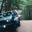 man looking over map on a road in the woods.