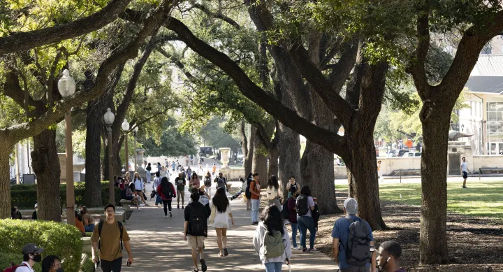 Student walking in the shade on the UT Austin campus
