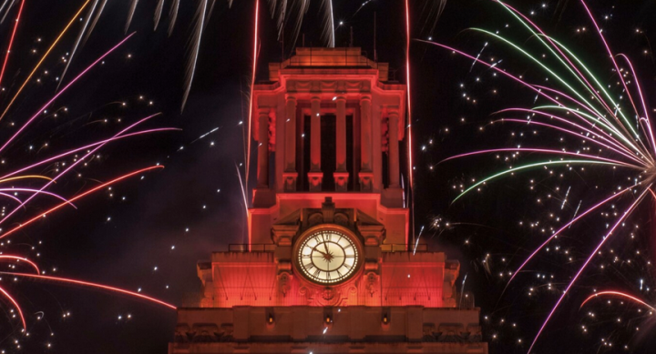 UT Tower shaded in burnt orange with fireworks