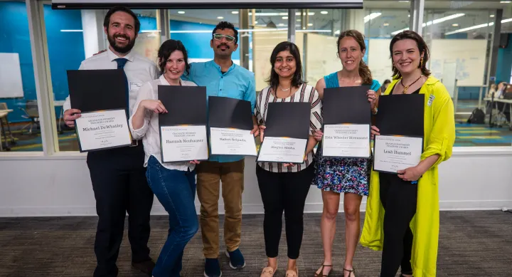 GTS Presenters. Two males and three females side by side holding certificates. 