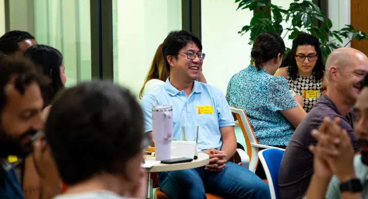Group of multiethnic faculty smiling and working in groups