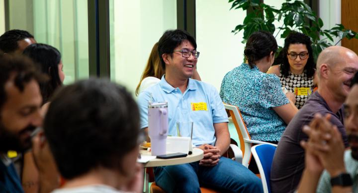Group of multiethnic faculty smiling and working in groups