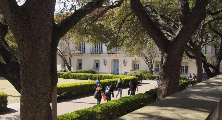 Main Mall through trees with students and Battle Hall