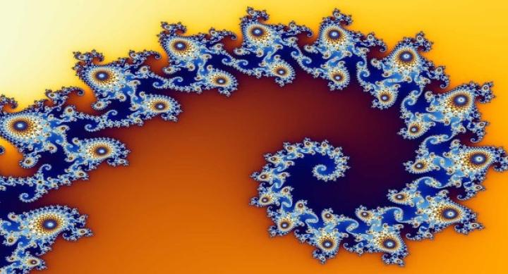 Partial view of the Mandelbrot set, which looks like a blue spiraling figure on top of a yellow/orange background. The spiral features shapes branching off of it that are micro-sized versions of the main shape, called a fractal.