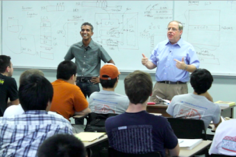 Two instructors in sharing with students in class.