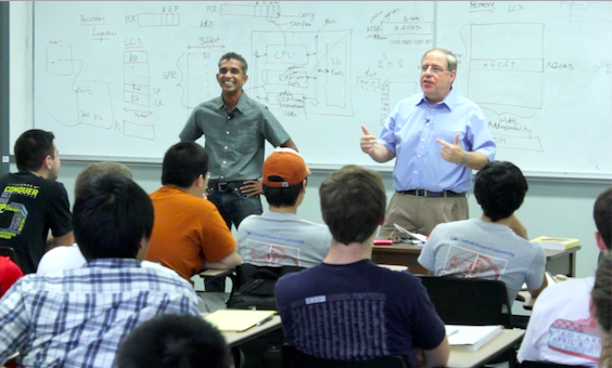 Two instructors in sharing with students in class.